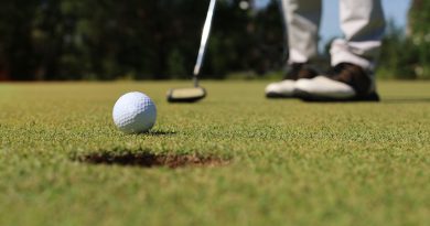 A person is practicing the timing of their golf swing in cold weather.